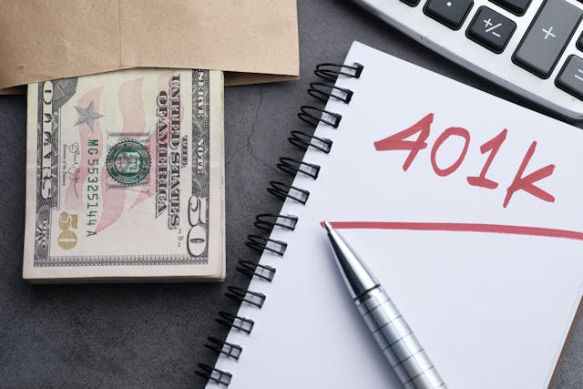 notebook with 401k next to money
