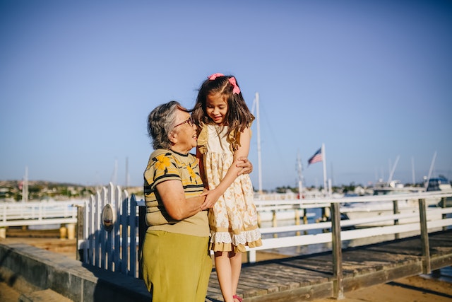 older woman hugging girl