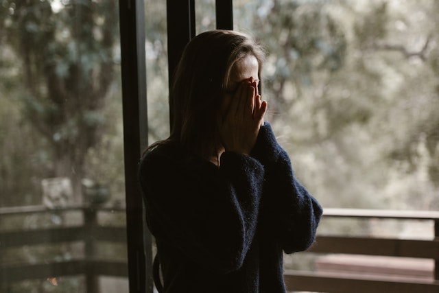 stressed woman covering face
