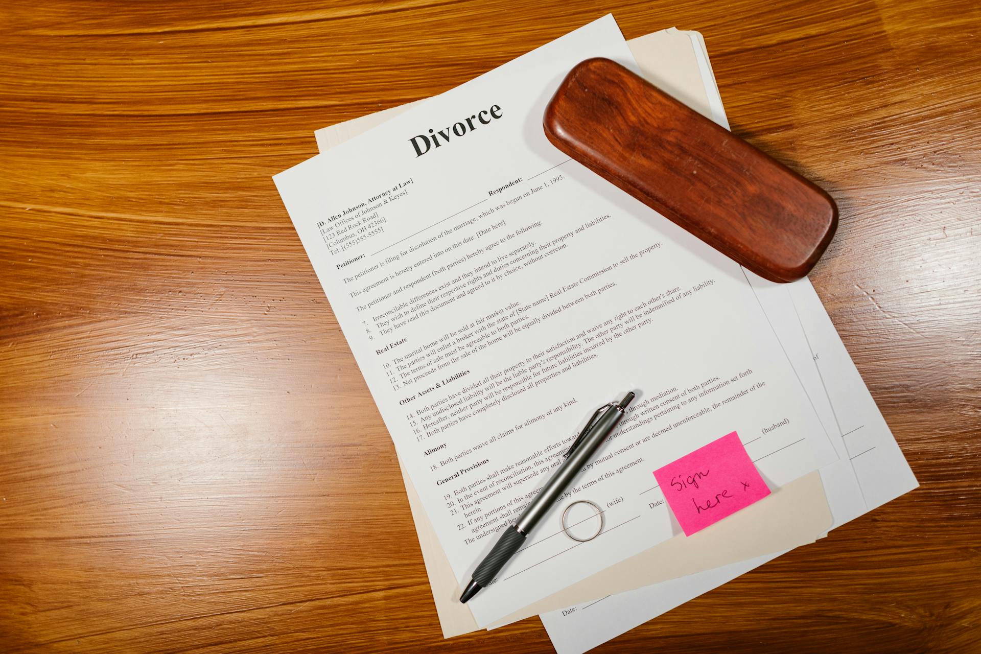 divorce papers with ring and pen