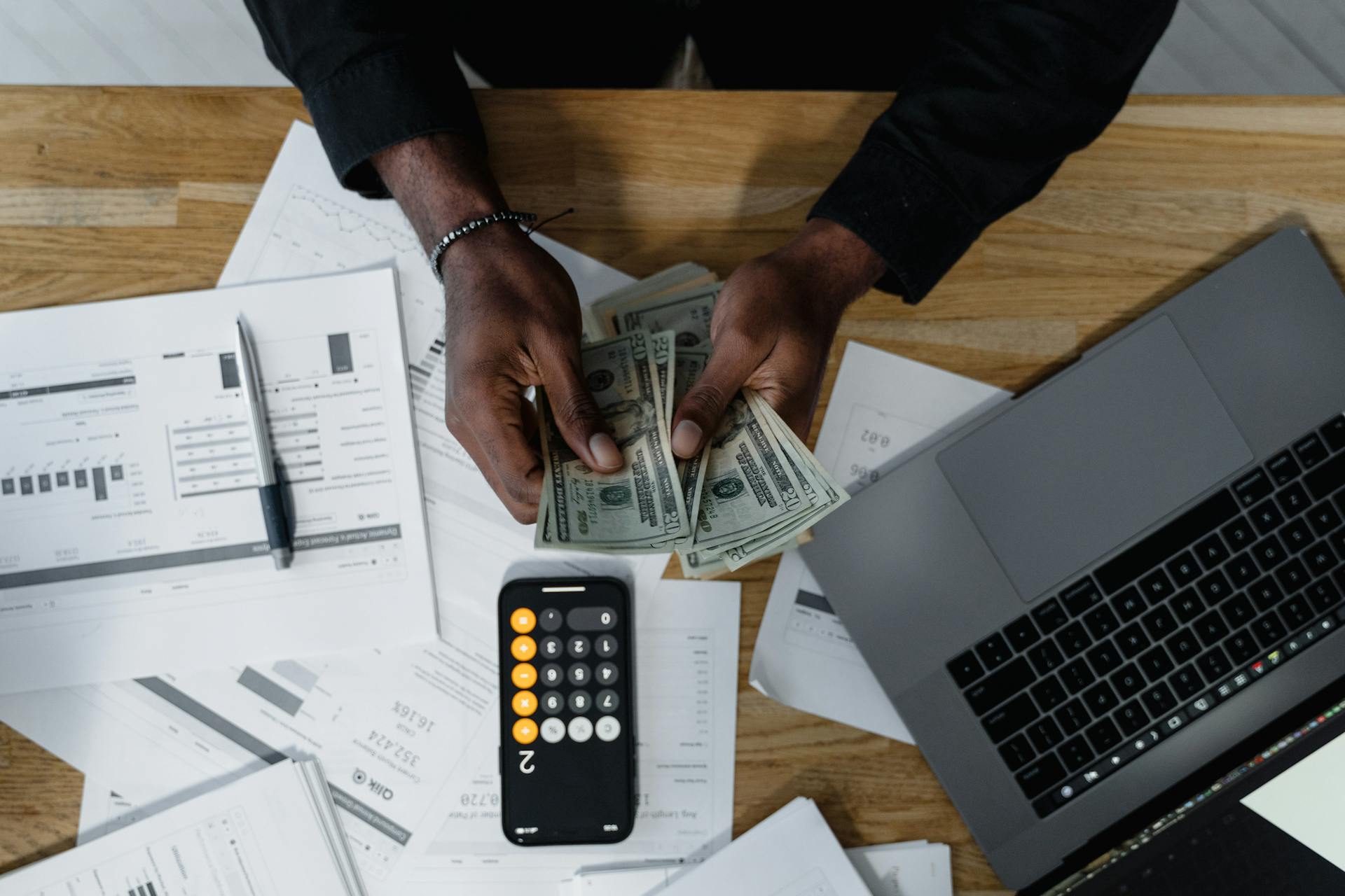 person counting money and doing math